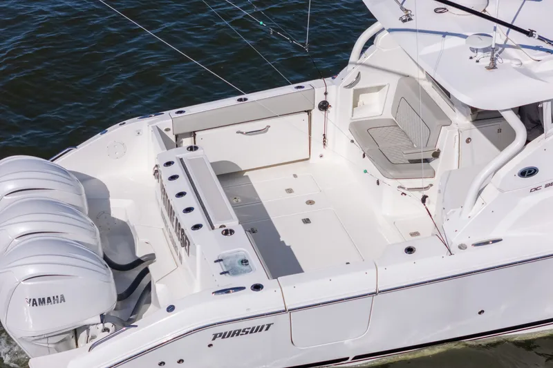 Slide: The Image of 2021 Pursuit DC 365 Dual Console boat with Yamaha engines on water. - 7