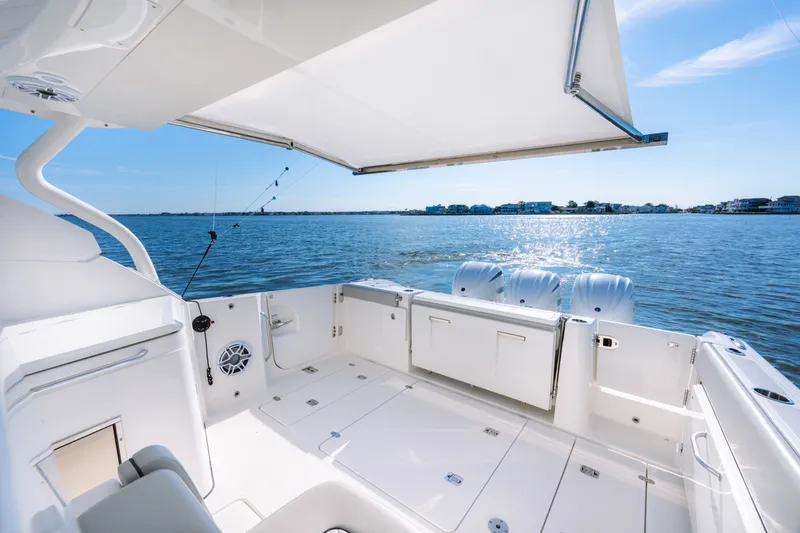 Slide: The Image of 2021 Pursuit DC 365 Dual Console boat with spacious deck and ocean view. - 31