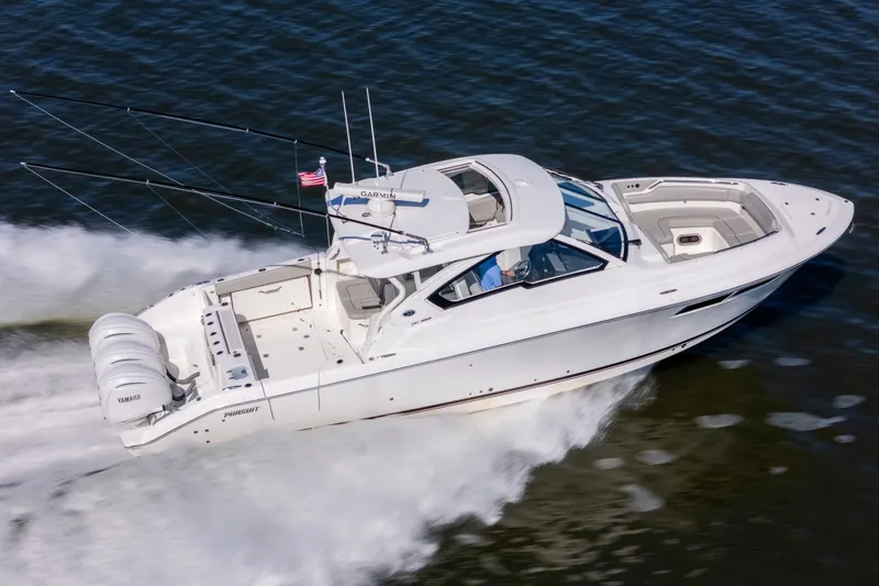 Slide: The Image of 2021 Pursuit DC 365 Dual Console boat cruising on water with Yamaha engines. - 0