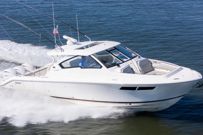 Slide: The Image of 2021 Pursuit DC 365 Dual Console boat cruising on open water. - 3