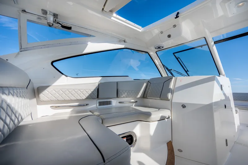 Slide: The Image of Luxurious interior of 2021 Pursuit DC 365 Dual Console boat with plush seating and panoramic windows. - 43