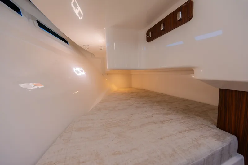 Slide: The Image of Interior cabin of 2021 Pursuit DC 365 Dual Console boat, featuring sleek design and ambient lighting. - 44