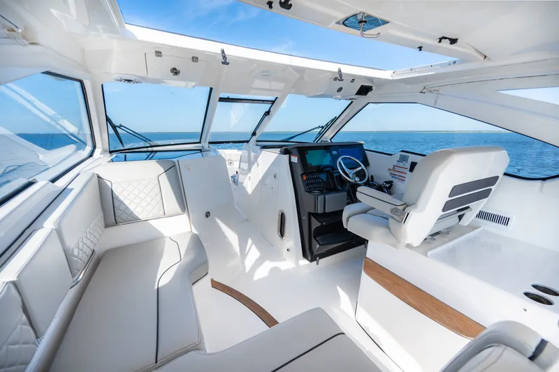 Slide: The Image of 2021 Pursuit DC 365 Dual Console interior with luxurious seating and ocean view. - 33