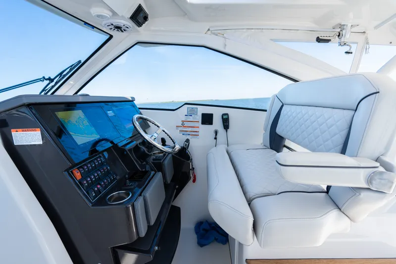 Slide: The Image of 2021 Pursuit DC 365 Dual Console interior with modern helm and luxurious seating. - 36