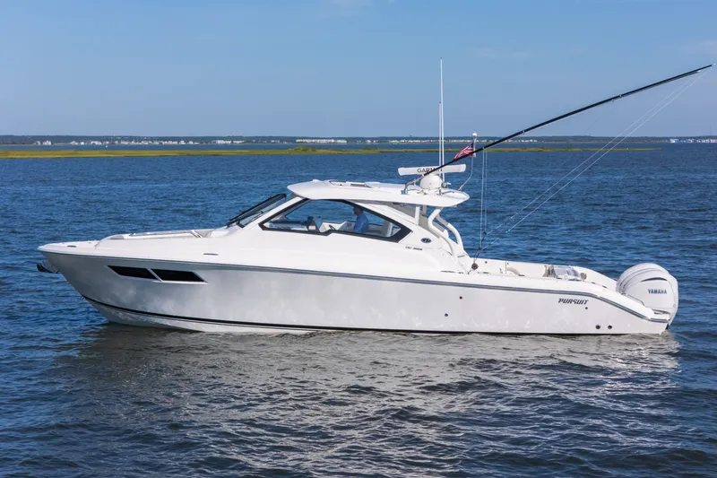 Slide: The Image of 2021 Pursuit DC 365 Dual Console boat cruising on open water. - 15