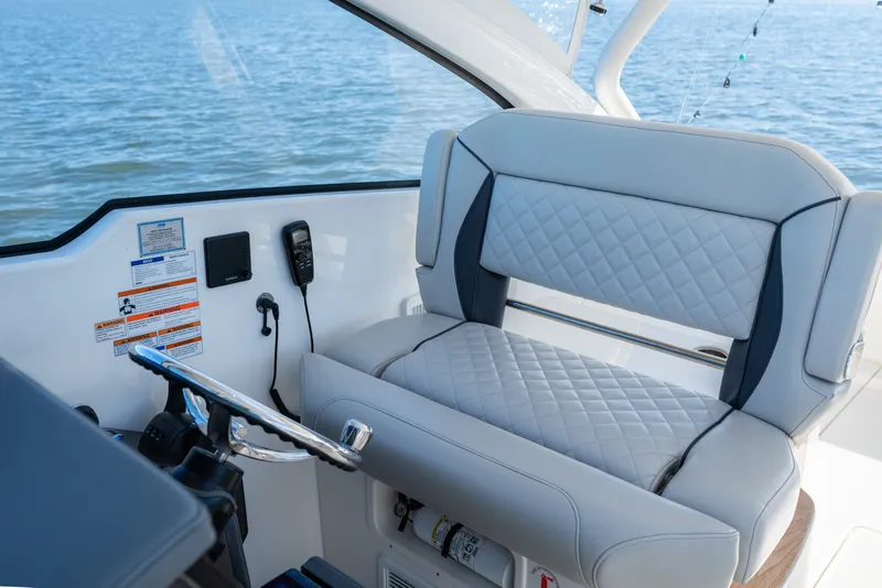 Slide: The Image of 2021 Pursuit DC 365 Dual Console boat interior with luxurious seating and steering wheel. - 39