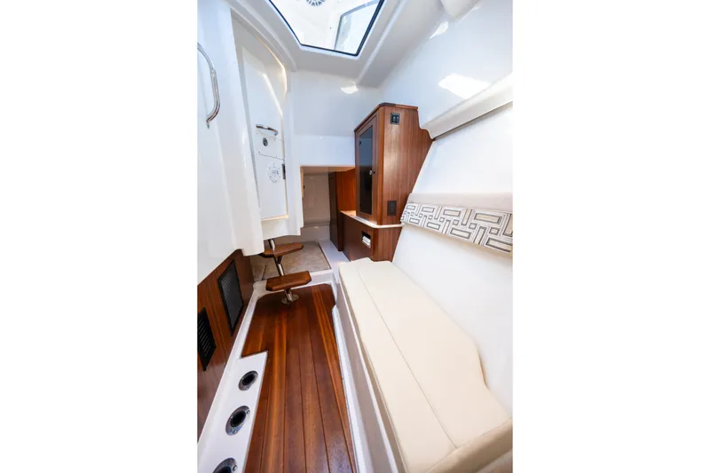 Slide: The Image of Interior of 2021 Pursuit DC 365 Dual Console boat with wood flooring and seating. - 45