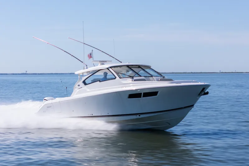 The Image of 2021 Pursuit DC 365 Dual Console boat cruising on open water. - 1