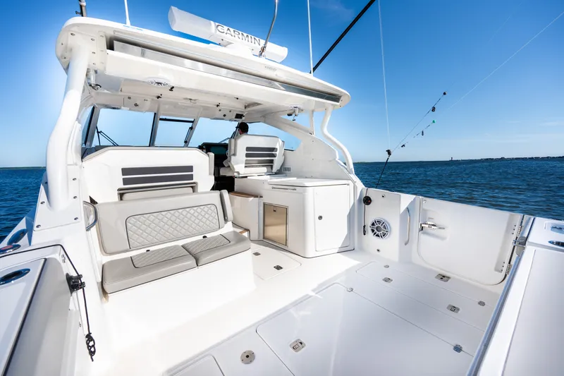 Slide: The Image of 2021 Pursuit DC 365 Dual Console boat interior with seating and ocean view. - 27