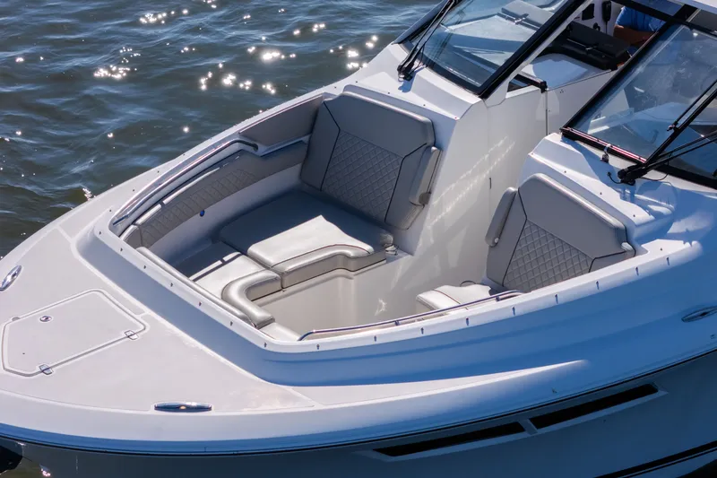 Slide: The Image of 2021 Pursuit DC 365 Dual Console boat with spacious seating on calm water. - 11
