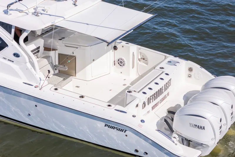 Slide: The Image of 2021 Pursuit DC 365 Dual Console boat with Yamaha engines on water. - 18