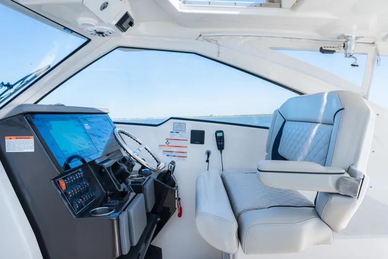 Slide: The Image of 2021 Pursuit DC 365 Dual Console helm with modern controls and comfortable seating. - 34