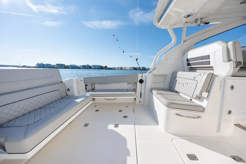 Slide: The Image of 2021 Pursuit DC 365 Dual Console boat interior with luxurious seating and ocean view. - 21