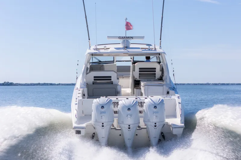 Slide: The Image of 2021 Pursuit DC 365 Dual Console boat cruising on open water. - 5