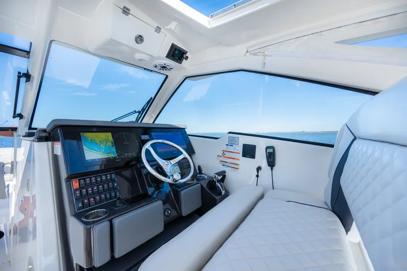 Slide: The Image of 2021 Pursuit DC 365 Dual Console boat interior with modern dashboard and navigation system. - 37