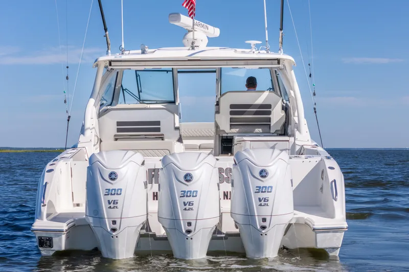 Slide: The Image of 2021 Pursuit DC 365 Dual Console boat with triple Yamaha 300 V6 engines on water. - 8