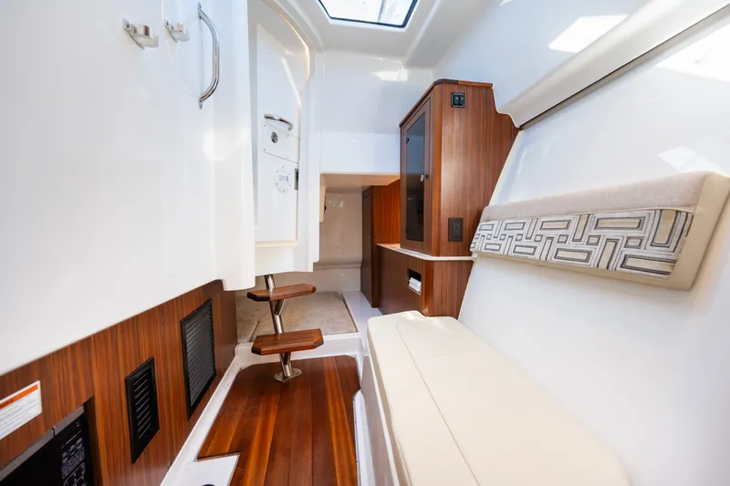 Slide: The Image of Interior of 2021 Pursuit DC 365 Dual Console boat with wood accents and seating. - 46