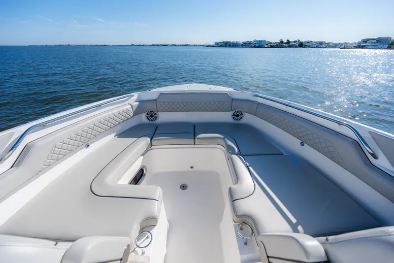 Slide: The Image of 2021 Pursuit DC 365 Dual Console boat interior with luxurious seating on calm water. - 41