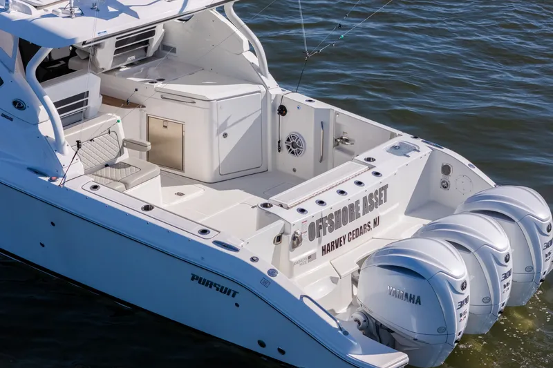 Slide: The Image of 2021 Pursuit DC 365 Dual Console boat with triple Yamaha engines on water. - 10