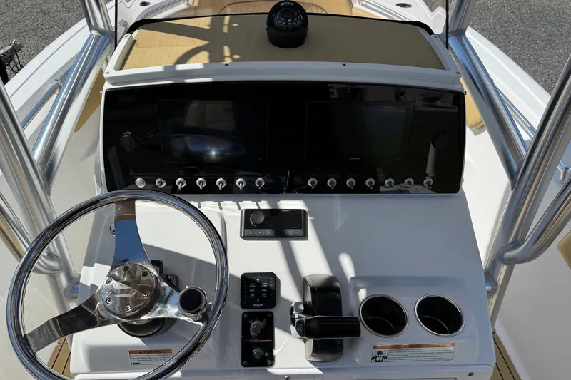 Slide: The Image of 2022 Sportsman Open 212 Center Console dashboard with steering wheel and controls. - 10