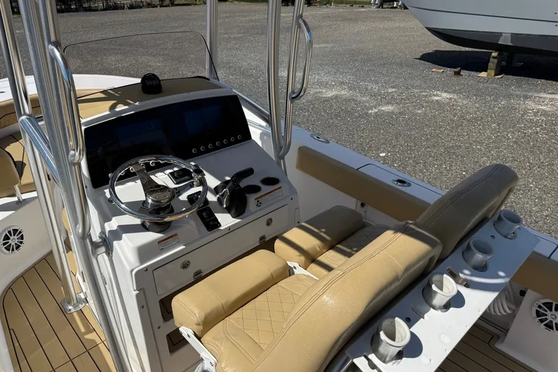 Slide: The Image of 2022 Sportsman Open 212 Center Console boat interior with steering wheel and seating. - 9