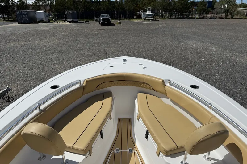 Slide: The Image of 2022 Sportsman Open 212 Center Console boat with tan seating in a parking area. - 3