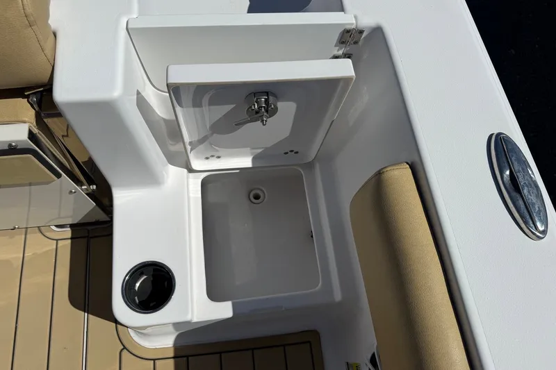 Slide: The Image of 2022 Sportsman Open 212 Center Console boat sink and storage compartment. - 17