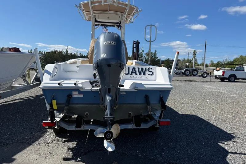 Slide: The Image of 2022 Sportsman Open 212 Center Console boat with Yamaha 150 engine, parked outdoors. - 22