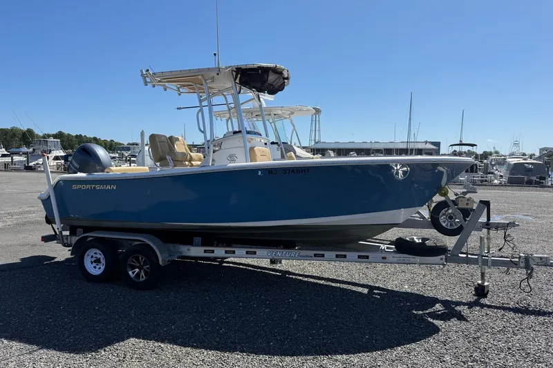 The Image of 2022 Sportsman Open 212 Center Console boat on trailer at marina. - 0