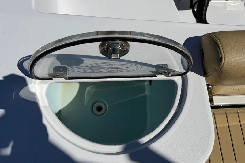 Slide: The Image of A round, transparent lid on a white boat with a brown seat nearby. - 18