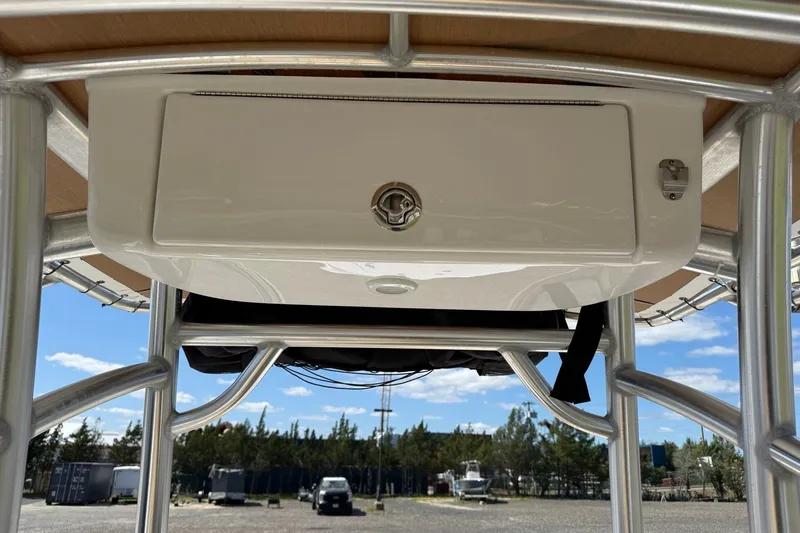Slide: The Image of 2022 Sportsman Open 212 Center Console storage compartment under T-top. - 13