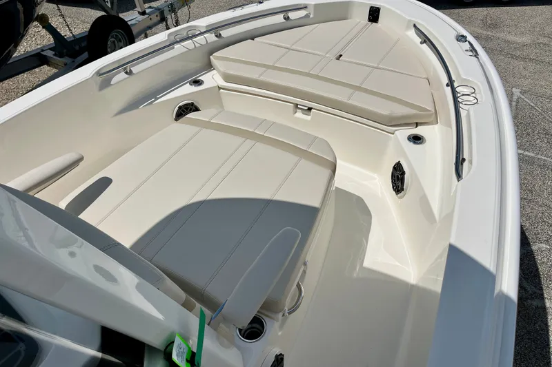 Slide: The Image of 2027 Boston Whaler 220 Dauntless boat interior with cushioned seating and sleek design. - 22