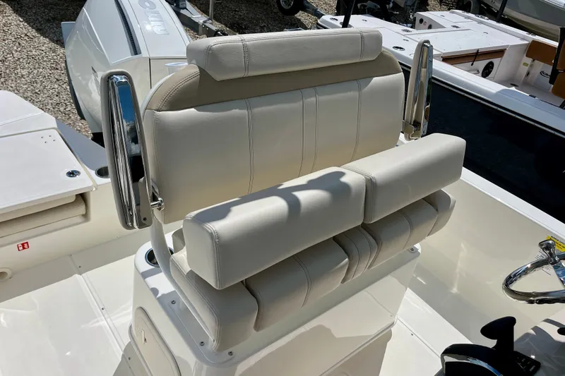 Slide: The Image of Boston Whaler 220 Dauntless 2027 boat seating with chrome accents and white upholstery. - 13