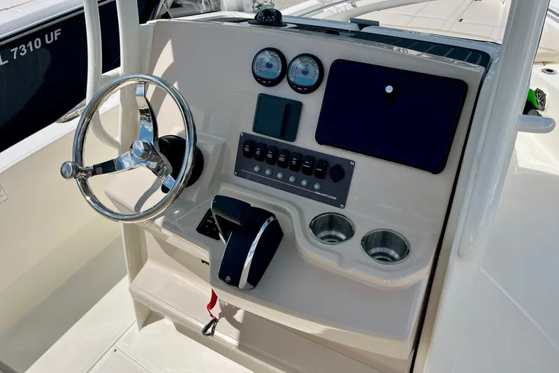 Slide: The Image of Steering console of 2027 Boston Whaler 220 Dauntless boat with gauges and controls. - 16