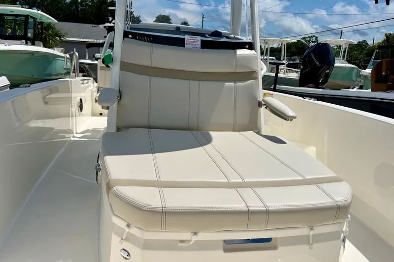Slide: The Image of 2027 Boston Whaler 220 Dauntless boat interior with cushioned seating and armrests. - 26
