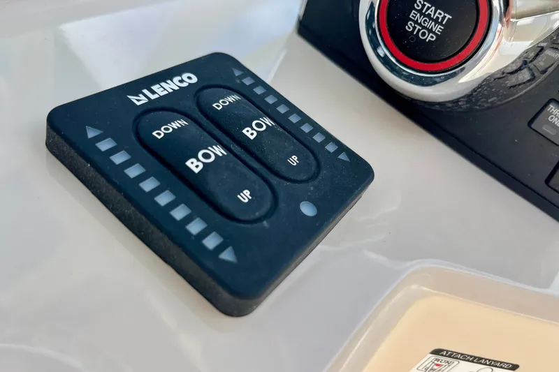 Slide: The Image of Control panel on a 2027 Boston Whaler 220 Dauntless boat, featuring Lenco trim tab switches. - 19