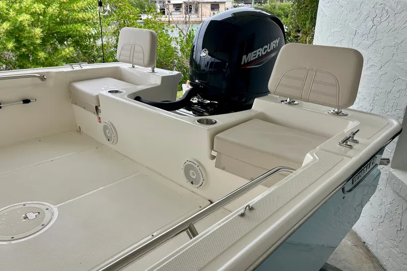 Slide: The Image of 2027 Boston Whaler 190 Montauk boat interior with Mercury engine, featuring seating and storage. - 5