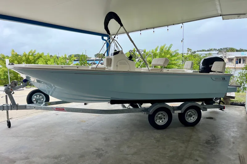 Slide: The Image of 2027 Boston Whaler 190 Montauk boat on trailer under shelter. - 3