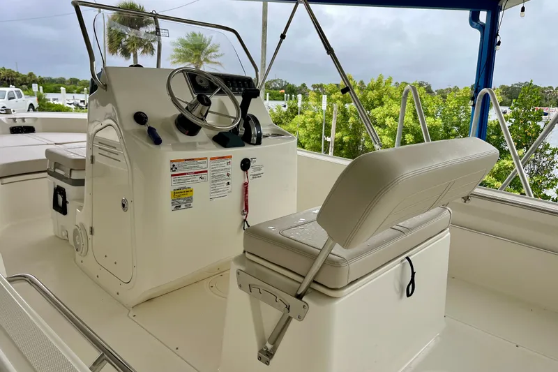 Slide: The Image of 2027 Boston Whaler 190 Montauk boat interior with steering console and seating. - 6