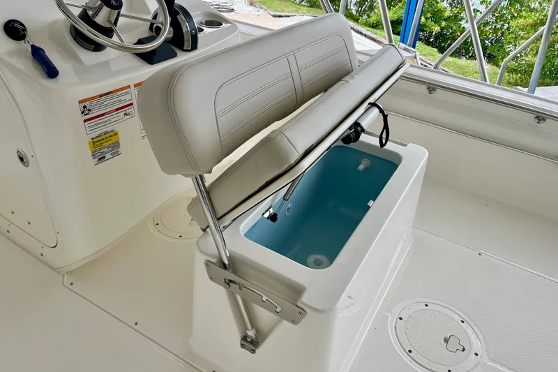 Slide: The Image of 2027 Boston Whaler 190 Montauk boat interior with open storage compartment and steering console. - 8