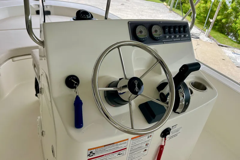 Slide: The Image of Steering console of a 2027 Boston Whaler 190 Montauk boat, featuring gauges and controls. - 7