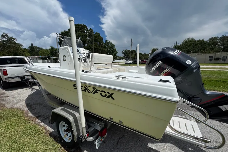 Slide: The Image of A 2005 Sea Fox 197 Center Console boat on a trailer, featuring a Yamaha outboard motor. - 2