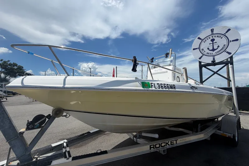 Slide: The Image of 2005 Sea Fox 197 Center Console boat on trailer under a partly cloudy sky. - 7