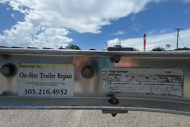 Slide: The Image of Trailer serviced by On-Site Trailer Repair, contact 305-216-4932, under a cloudy sky. - 54