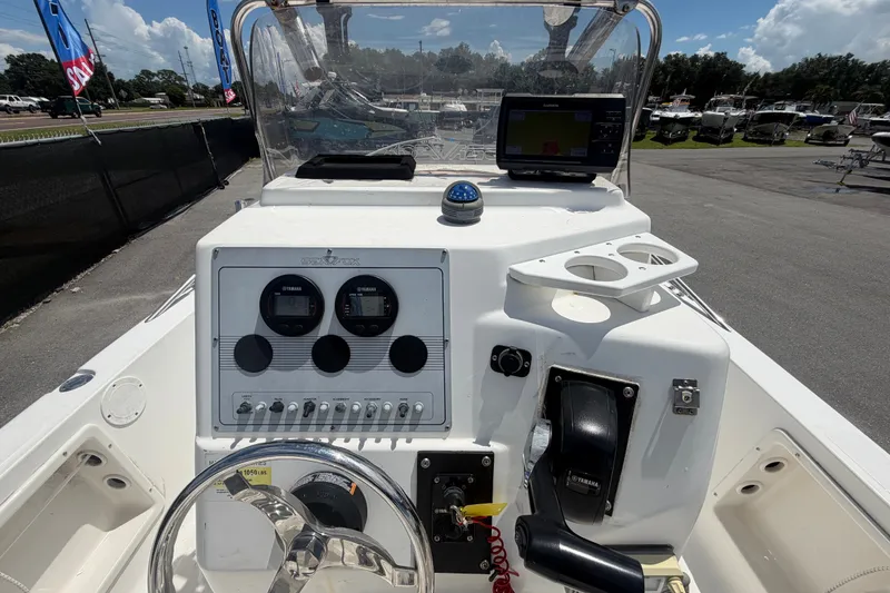 Slide: The Image of 2005 Sea Fox 197 Center Console boat dashboard with gauges and controls. - 16
