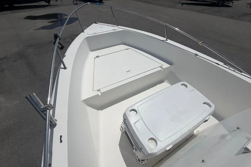 Slide: The Image of 2005 Sea Fox 197 Center Console boat interior with storage compartments and cooler. - 25