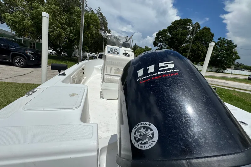 Slide: The Image of 2005 Sea Fox 197 Center Console boat with 115 horsepower engine, parked outdoors. - 3