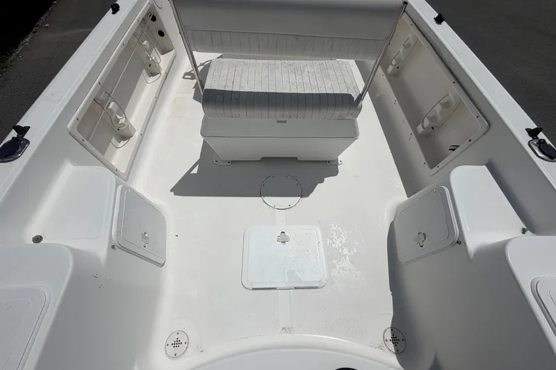 Slide: The Image of 2005 Sea Fox 197 Center Console boat interior with seating and storage compartments. - 11