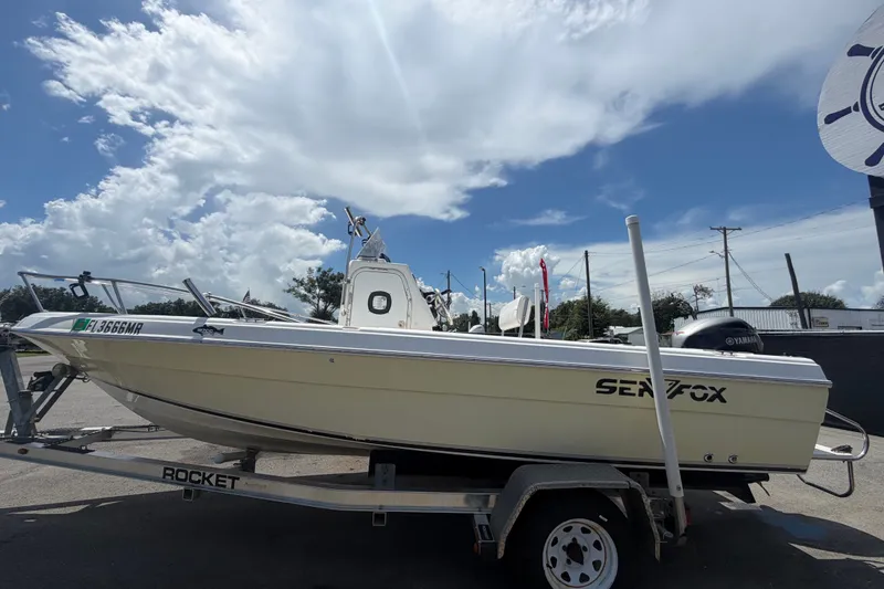 Slide: The Image of 2005 Sea Fox 197 Center Console boat on trailer under a bright blue sky. - 6