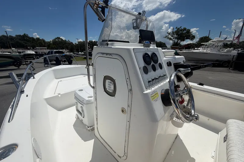 Slide: The Image of 2005 Sea Fox 197 Center Console boat with steering wheel and control panel, docked outdoors. - 20